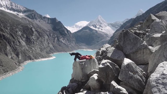 Woman enjoying the marvelous panoramic view from the peak of the park Huascaran and lake paron, Huaraz.4k