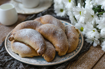 Croissants with cheese cup of tea and chrysanthemums for breakfa