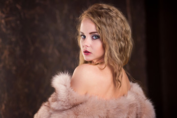 young beautiful woman in underwear and a fur coat