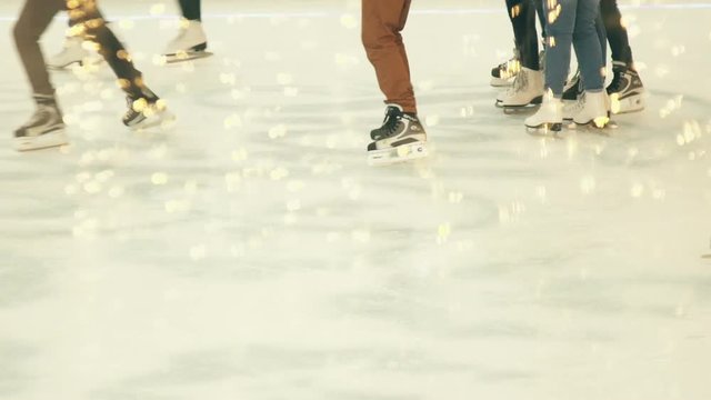 Young People Skating on the Ice Rink