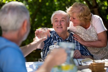 Senior couples having breakfast in garden