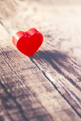 Fototapeta premium Valentines Day background with red heart on old wooden board wi