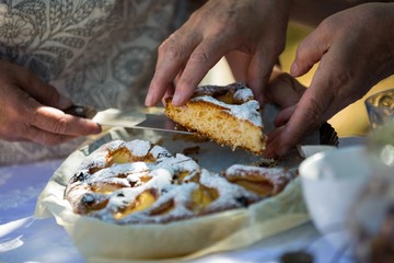 Senior woman serving breakfast in garden