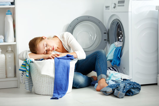 tired unhappy woman housewife is engaged in the laundry,