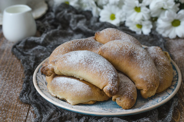 Croissants with cheese cup of tea and chrysanthemums for breakfa