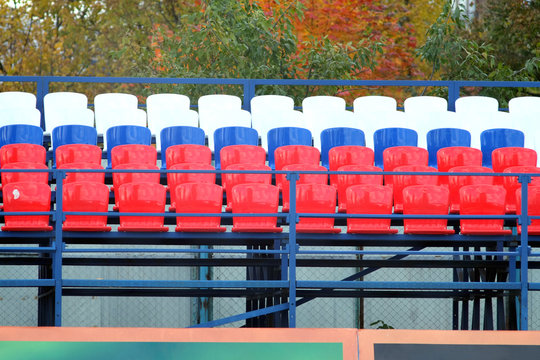 Grandstand stadium with many colored seats outdoors front view