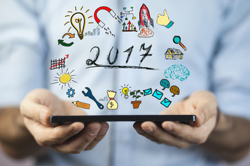 2017 concept with smartphone on man hand