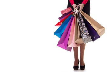 Lower close-up, standng girl holding shopping paper bags and pac