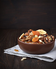 Dried fruits and nuts in bowl on a table.