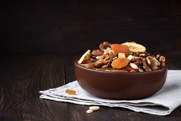 Tasty dried fruits and nuts on wooden table.