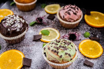 Cupcakes with fruit and powdered sugar on a dark background. Top view. Close-up