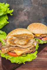 Great Hamburger and french fries on a wooden table in rustic style