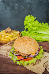 Great Hamburger and french fries on a wooden table in rustic style
