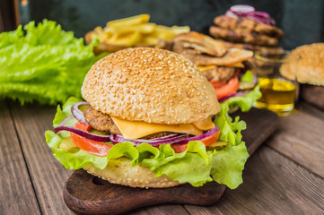 Great Hamburger and french fries on a wooden table in rustic style. Close-up
