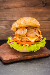 Great Hamburger and french fries on a wooden table in rustic style