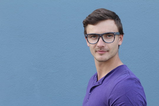 Portrait of Eastern European College Student with glasses. Wearing green v-neck T shirt on the street in hot summer, relaxing.