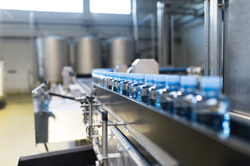 Water factory - Close up shot of water bottling line for processing and bottling pure mineral...