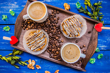 Cappuccino and cakes. On a blue background. Top view. Close-up
