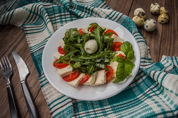 Arugula Salad - Caprese . Wooden background. Top view. Close-up