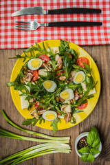 Warm salad with bacon and arugula. Wooden rustic background. top view