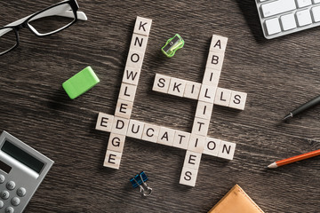 Conceptual business keywords on table with elements of game making crossword