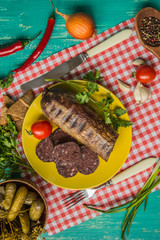 Homemade blood sausage with offal on a turquoise wooden background. top view. Close-up