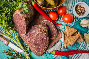 Homemade blood sausage with offal on a turquoise wooden background. top view. Close-up
