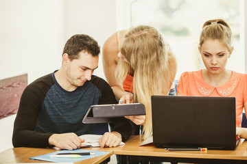Students and teacher tutor in classroom