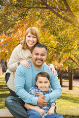 Fototapeta premium Happy Mixed Race Hispanic and Caucasian Family Portrait at the Park.