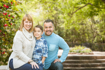 Fototapeta premium Happy Mixed Race Hispanic and Caucasian Family Portrait at the Park.