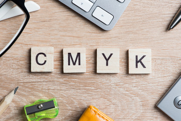 CMYK abbreviation of blocks as photography concept on business workplace