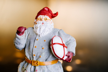 Statue of Santa Claus with modern look against a dark backdrop
