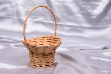 Fototapeta na wymiar Woven basket for wedding birthday flower arrangement on white sa
