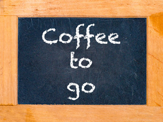 The coffee to go board with white chalk letters