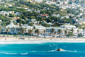 Fotobehang The coastal line of camps bay with the twelve apostle mountains behind it. Camps Bay is one of the most exclusive resort of south africa. © jon11
