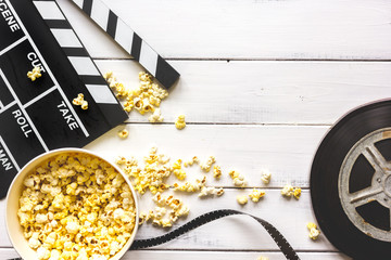 watching movie with popcorn on wooden background top view