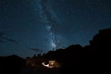 Cercles muraux Sécheresse Desert canyons with milky way stars at night and illuminated house