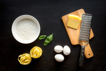 cooking process of pasta on dark background top view