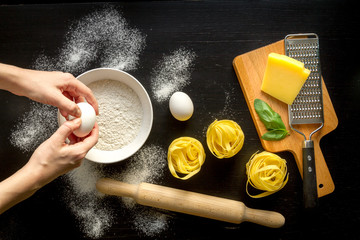 chef cooking pasta top view on dark background