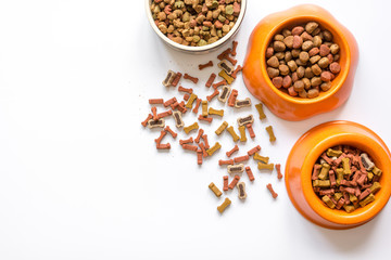 dry dog food in bowl on white background top view