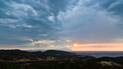 Fototapeta na wymiar Stormy sky, sunrise at sea and landscape around holy mountain Athos in Greece
