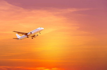 Fototapeta na wymiar airplane flying take off from runway on sunset 