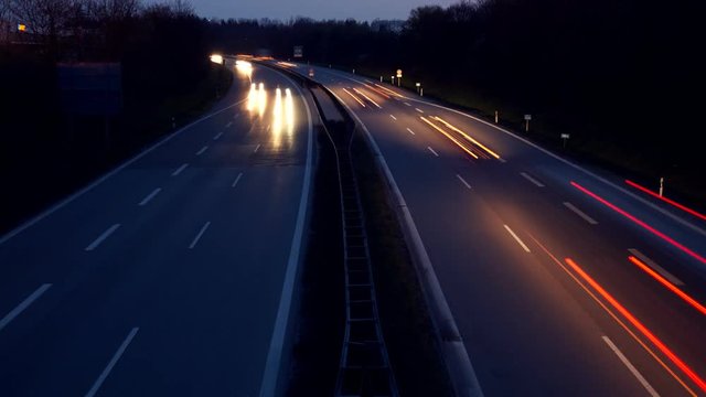 tilt up shot . Time lapse of moving cars on interstate in germany