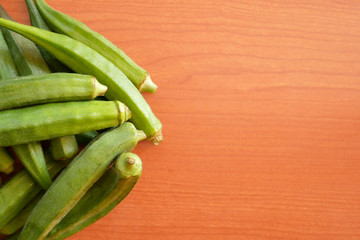 Okra, Lady’s finger, Gombo, Gumbo, Bendee, Quimbamto's seed on the old wooden