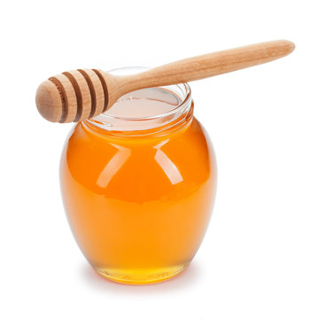 honey with wooden drizzler on white background