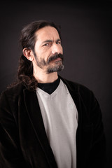 Handsome man doing different expressions in different sets of clothes: suspicion