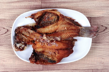 Deep fried tilapia fish topped  crispy red onion.