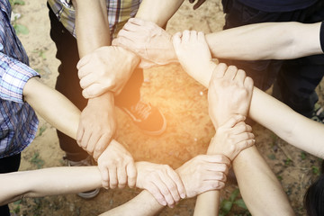 Many hands together holding hand to collaborate on some duty.