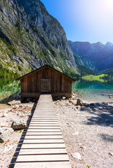 Boat dock hangar on Obersee mountain lake in Alps. Bavaria, Germany