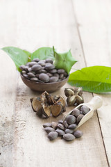 dried capsule seeds fruit of Sacha Inchi peanut on wooden